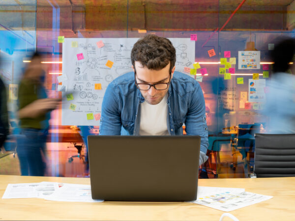 tech worker leaning into laptop